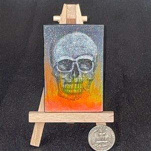Miniature 2”x3” black light paint skull painting.